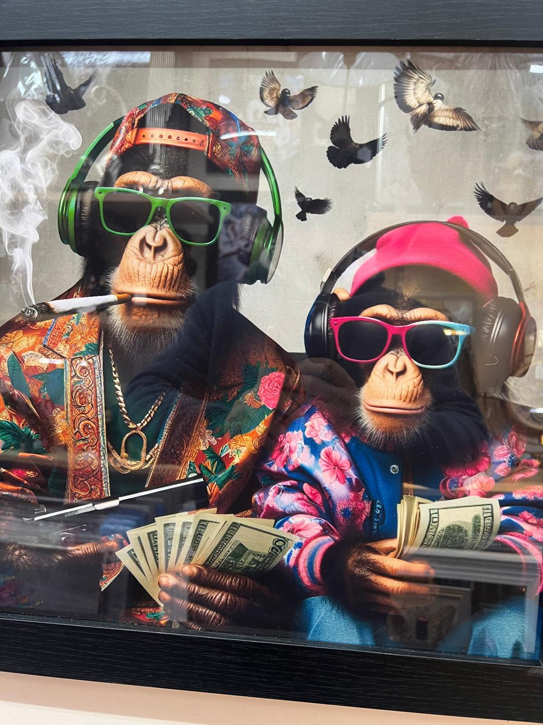 Black framed 2 monkeys with gun, dollars & wearing headphones wall art decor