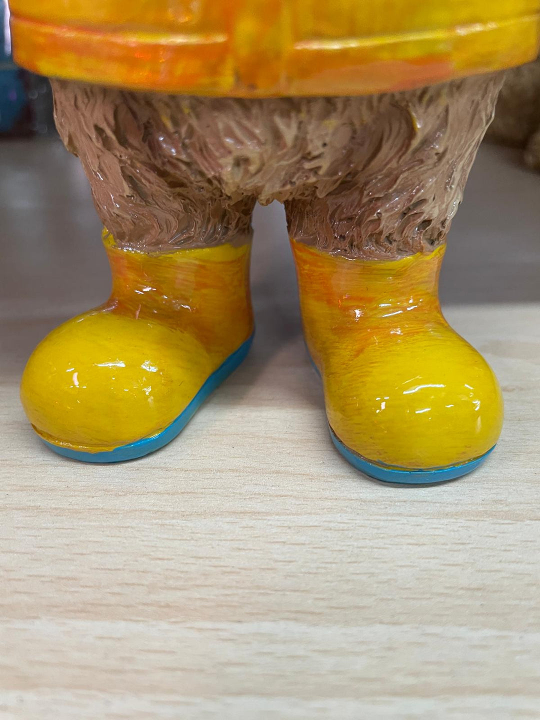 Highland cow in the rain with a blue umbrella yellow rain coat decor ornament