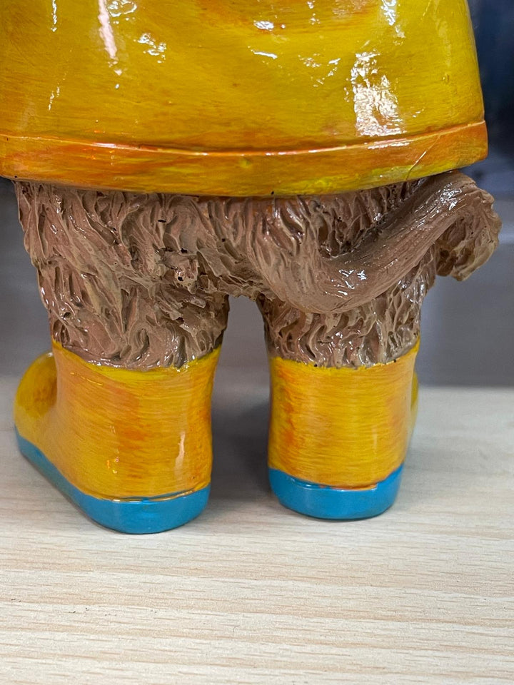 Highland cow in the rain with a blue umbrella yellow rain coat decor ornament