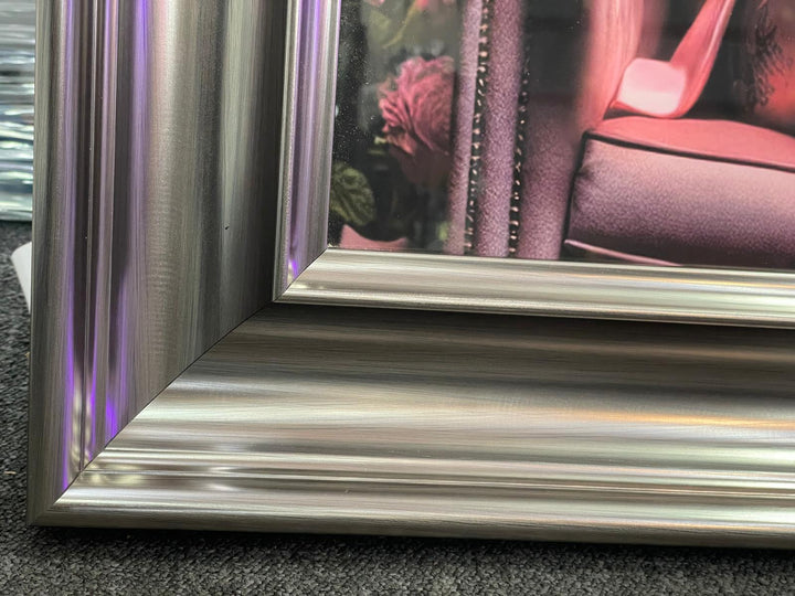 Graphite frame Lioness in a pink floral suit & couch wall art