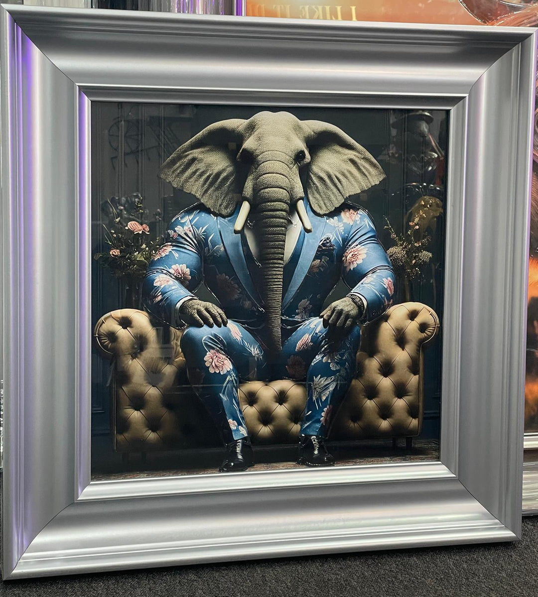 Silver frame picture of Elephant in a blue floral suit couch wall art