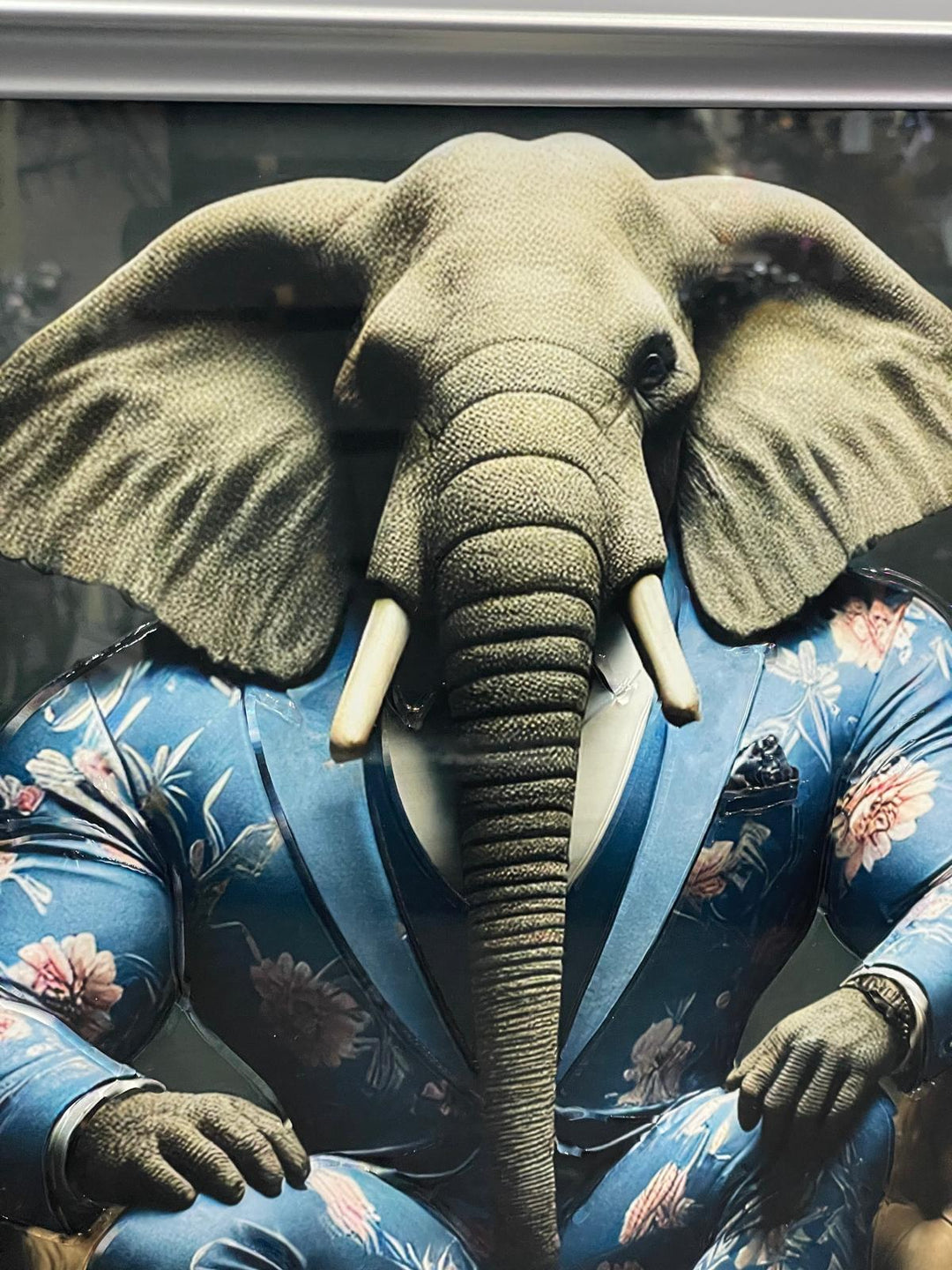 Silver frame picture of Elephant in a blue floral suit couch wall art
