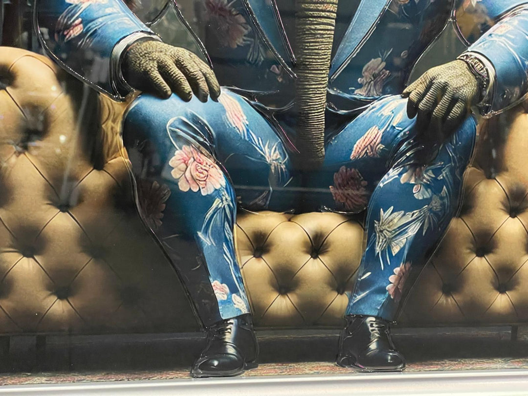 Silver frame picture of Elephant in a blue floral suit couch wall art