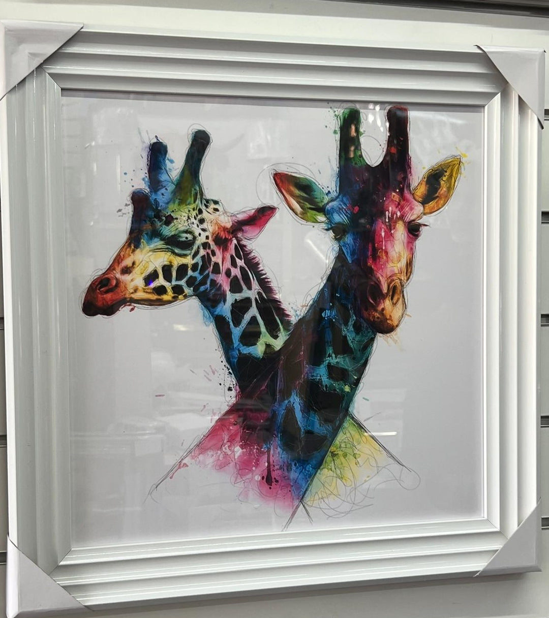 White framed intertwined Giraffes picture multi coloured wall art