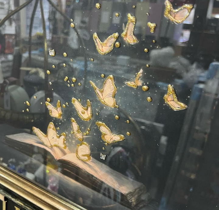 Magical butterflies flying from a book with two tone black and gold frame pictures