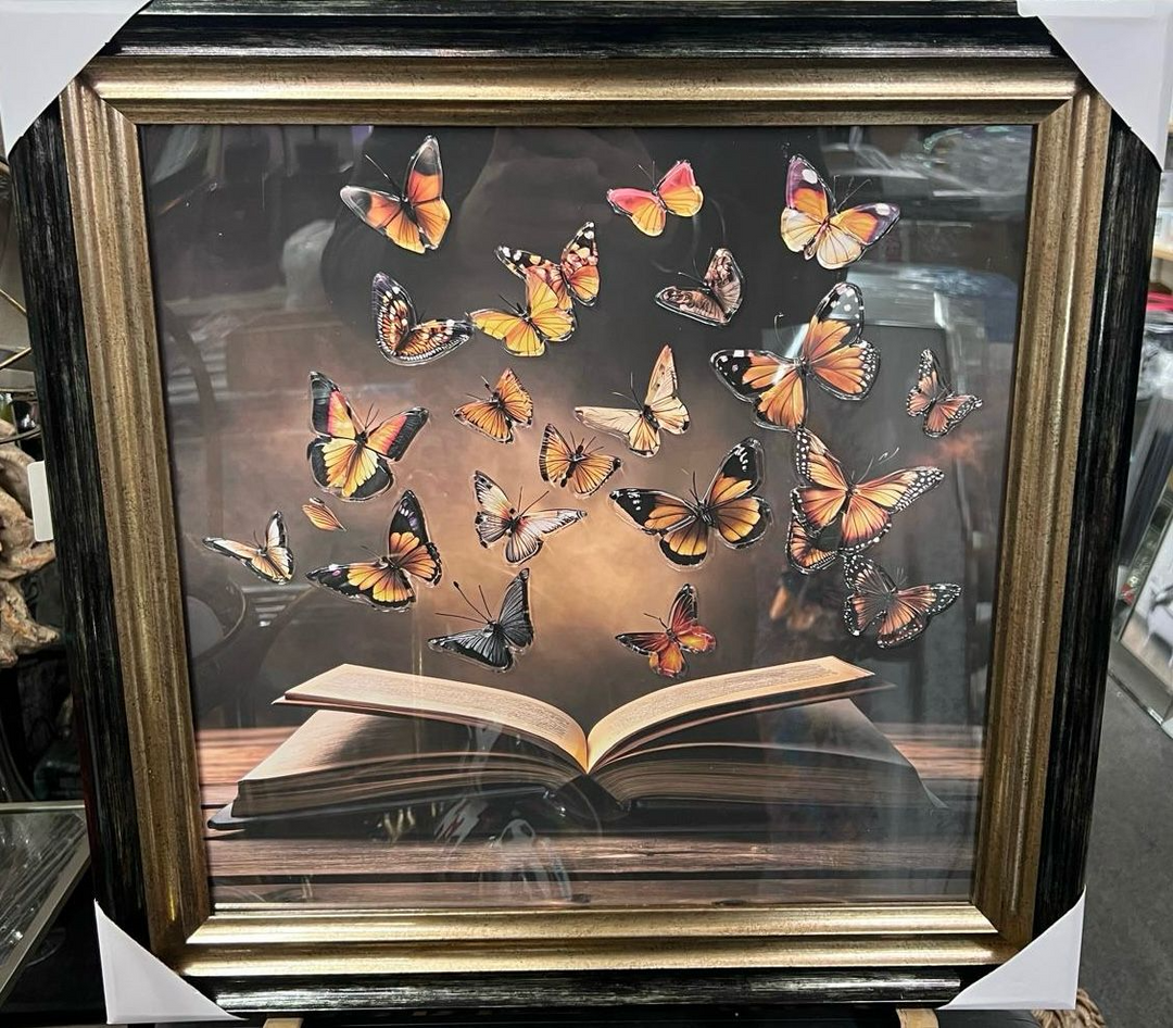 Magical butterflies flying from a book with two tone black and gold frame pictures