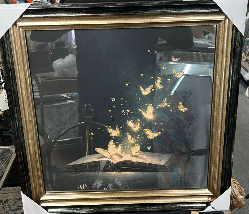 Magical butterflies flying from a book with two tone black and gold frame pictures